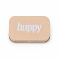 A closed, beige rectangular tin with "huppy" printed in white lowercase letters on the lid, on a white background.