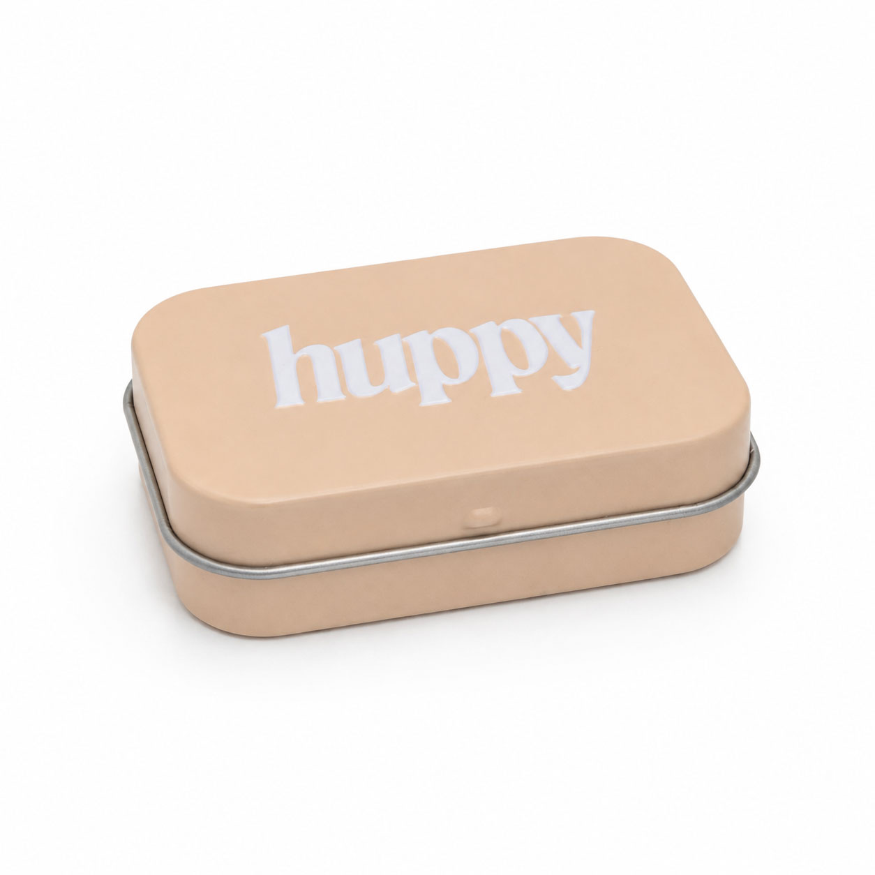 A three-quarter view of the closed beige tin with the white "huppy" logo on its lid, resting on a white background.