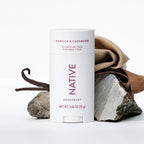 Front of Native Vanilla & Cashmere deodorant stick styled with dried vanilla beans, folded fabric, and grey rocks.