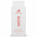 Front of a white Native Candy Cane body wash bottle with red bilingual text and candy cane graphic on white.