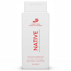 Front of a white Native Candy Cane body wash bottle with red bilingual text and candy cane graphic on white.