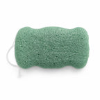 Flat, porous underside of a sage green konjac body sponge with a white hanging string on a white background.