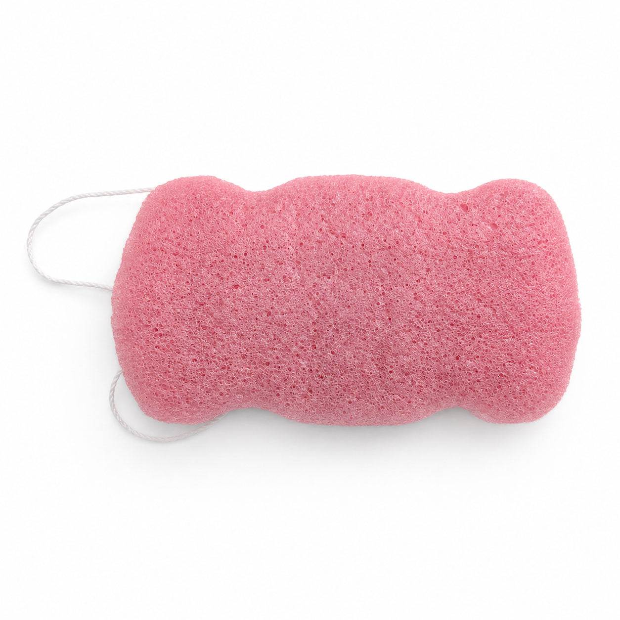 Flat, porous underside of a dusty pink konjac body sponge with a white hanging string on a white background.
