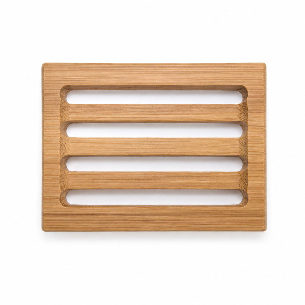 Top-down view of a rectangular bamboo soap dish with four open drainage slats on a plain white background.
