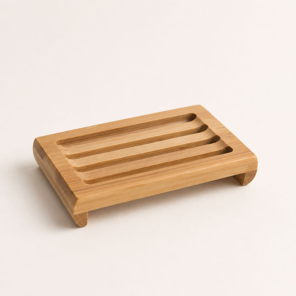 Slatted light wood soap dish shown from an elevated perspective against an off-white background.