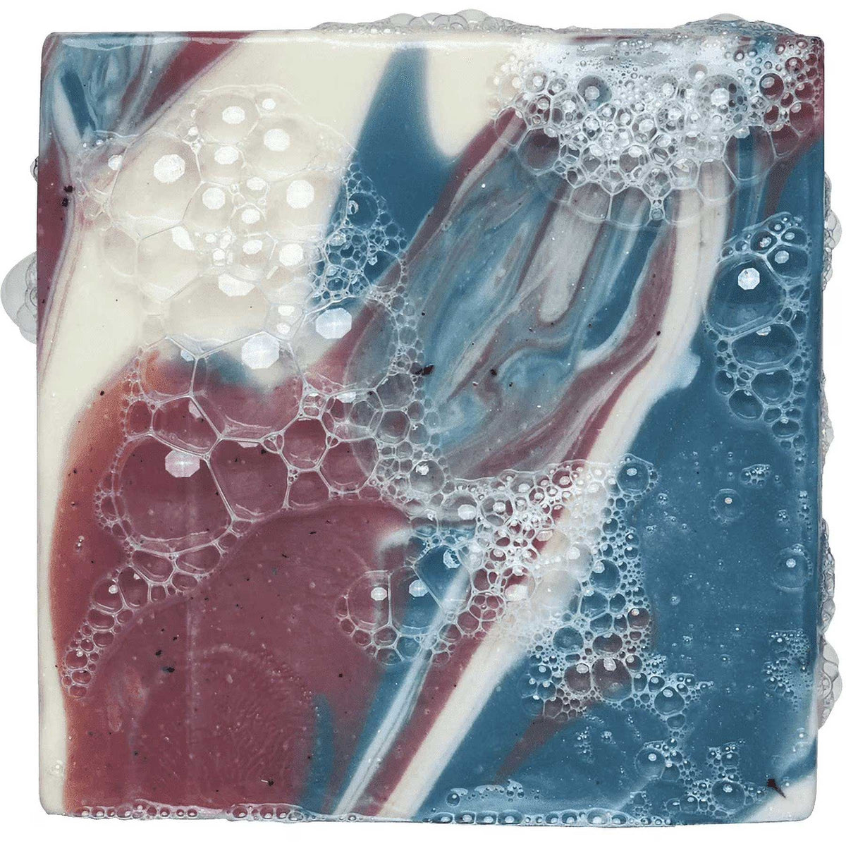 Square bar of red, white, and blue swirled soap covered with white lather bubbles.