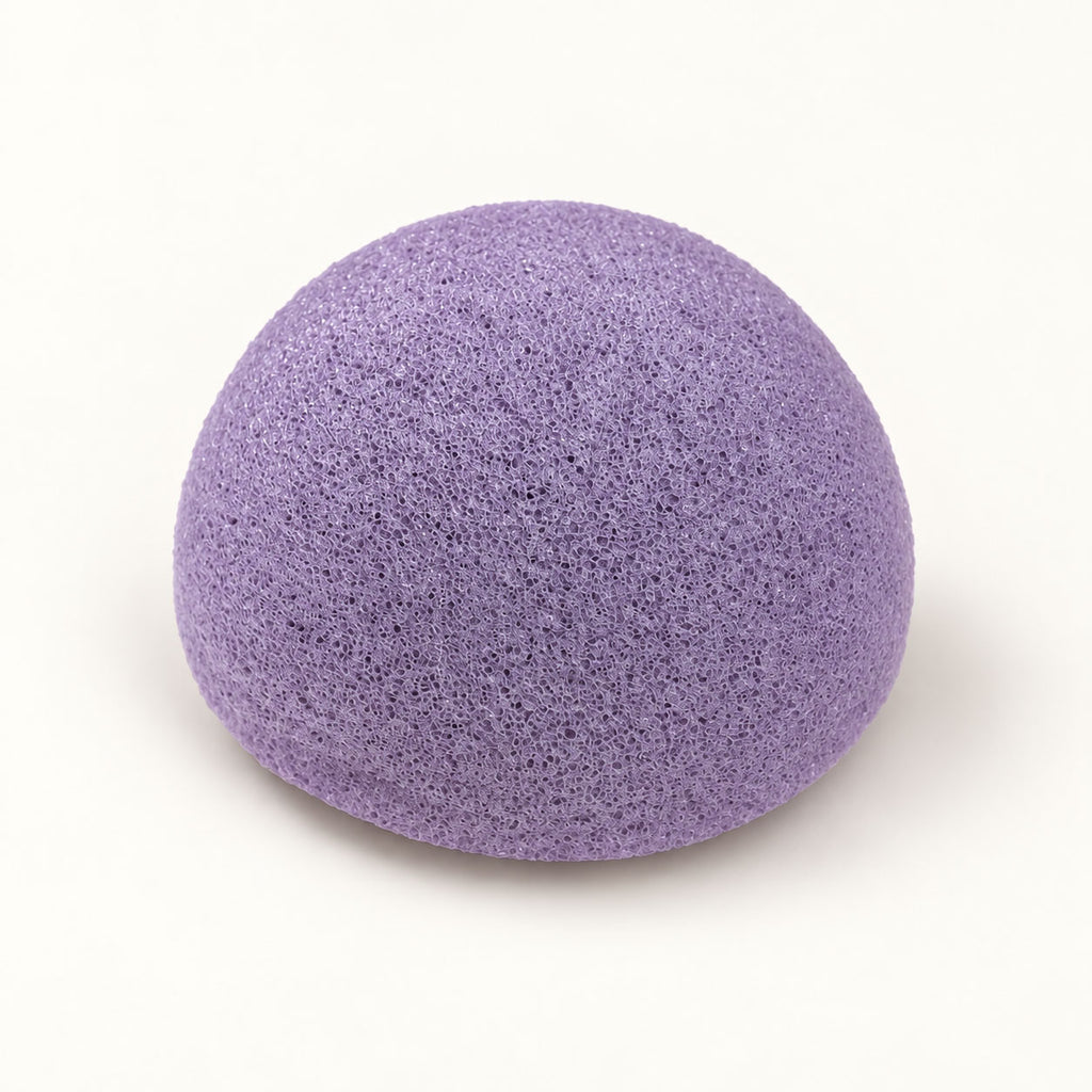 Dome-shaped purple konjac sponge on a plain white background.