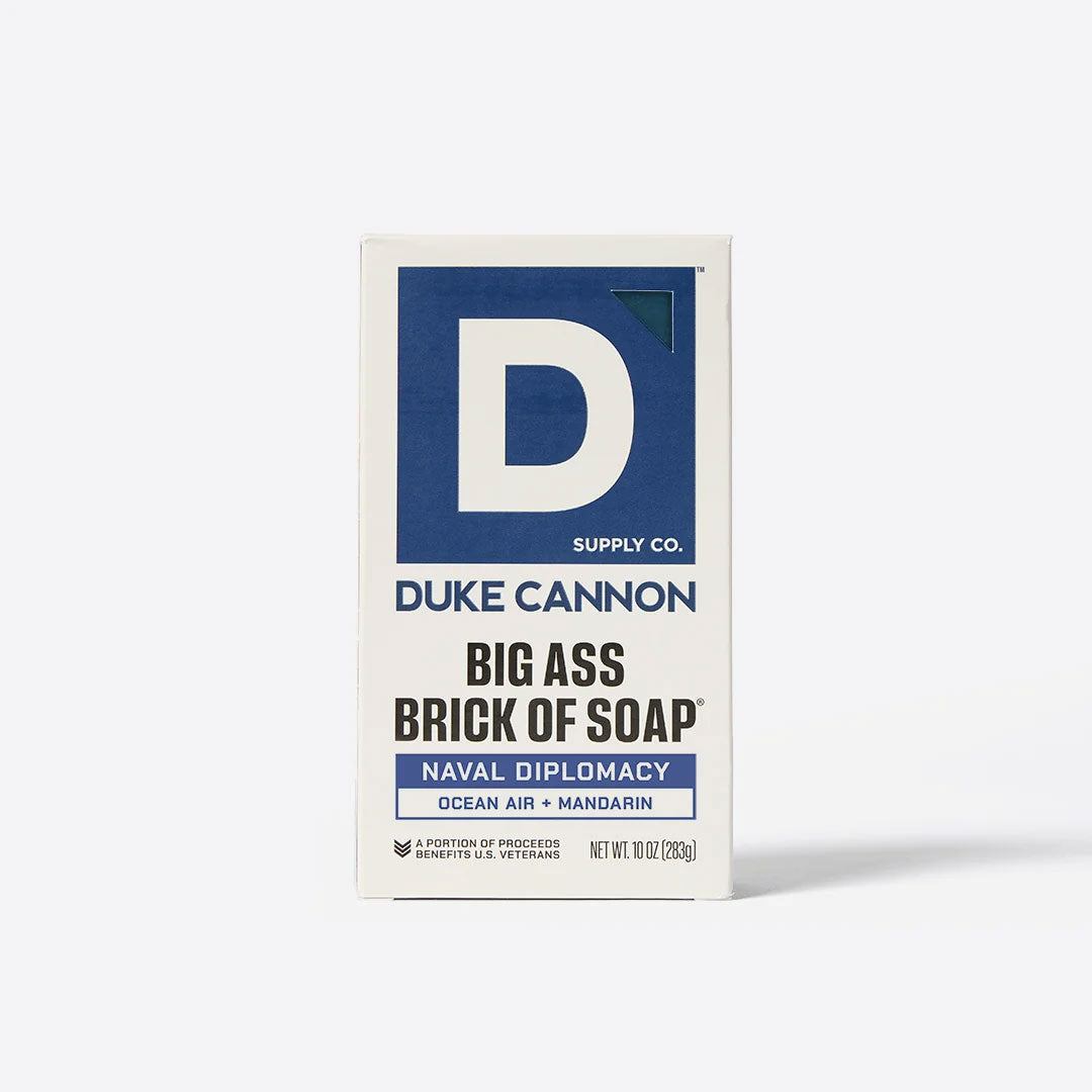 Front view of the white and blue boxed packaging for Duke Cannon Naval Diplomacy soap on a plain background.