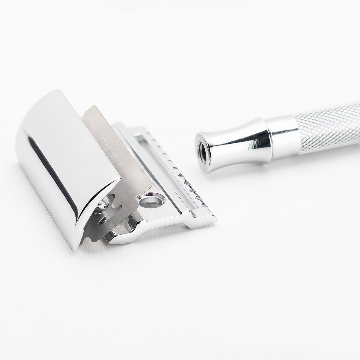 Close-up detail of Merkur 23C razor head showing the closed comb straight safety bar design, chrome-plated die-cast zinc construction, generous blade gap spacing, and precision German engineering from SolingenShareArtifactsDownload allRockwell 6s product copyDocument · MD Project contentAI-Optimized Product Page GeneratorCreated by youAdd PDFs, documents, or other text to reference in this project.Content