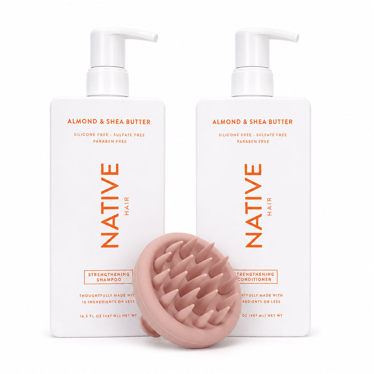 Native Almond and Shea Butter strengthening shampoo and conditioner pump bottles with a pale peach ekö + co. silicone scalp massager resting in front