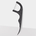 Close-up of The Humble Co. black dental floss pick displaying ergonomic curved handle with textured grip pattern and brand name embossed on side for secure handling