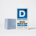 Duke Cannon Superior Big Ass Brick of Soap in light blue beside its white and blue branded cardboard box.