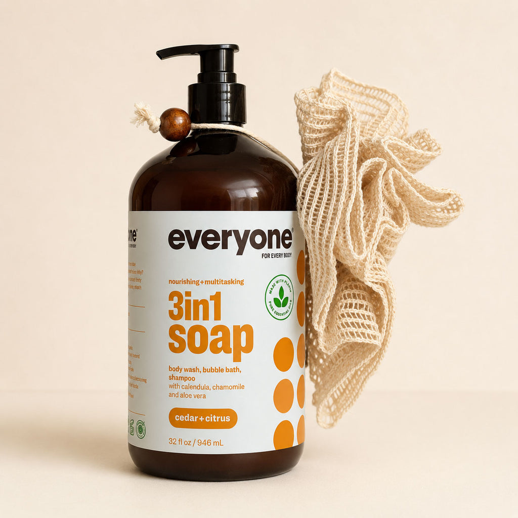 Everyone Cedar and Citrus 3-in-1 soap bottle beside a natural cream ramie bath pouf with cotton hanging cord
