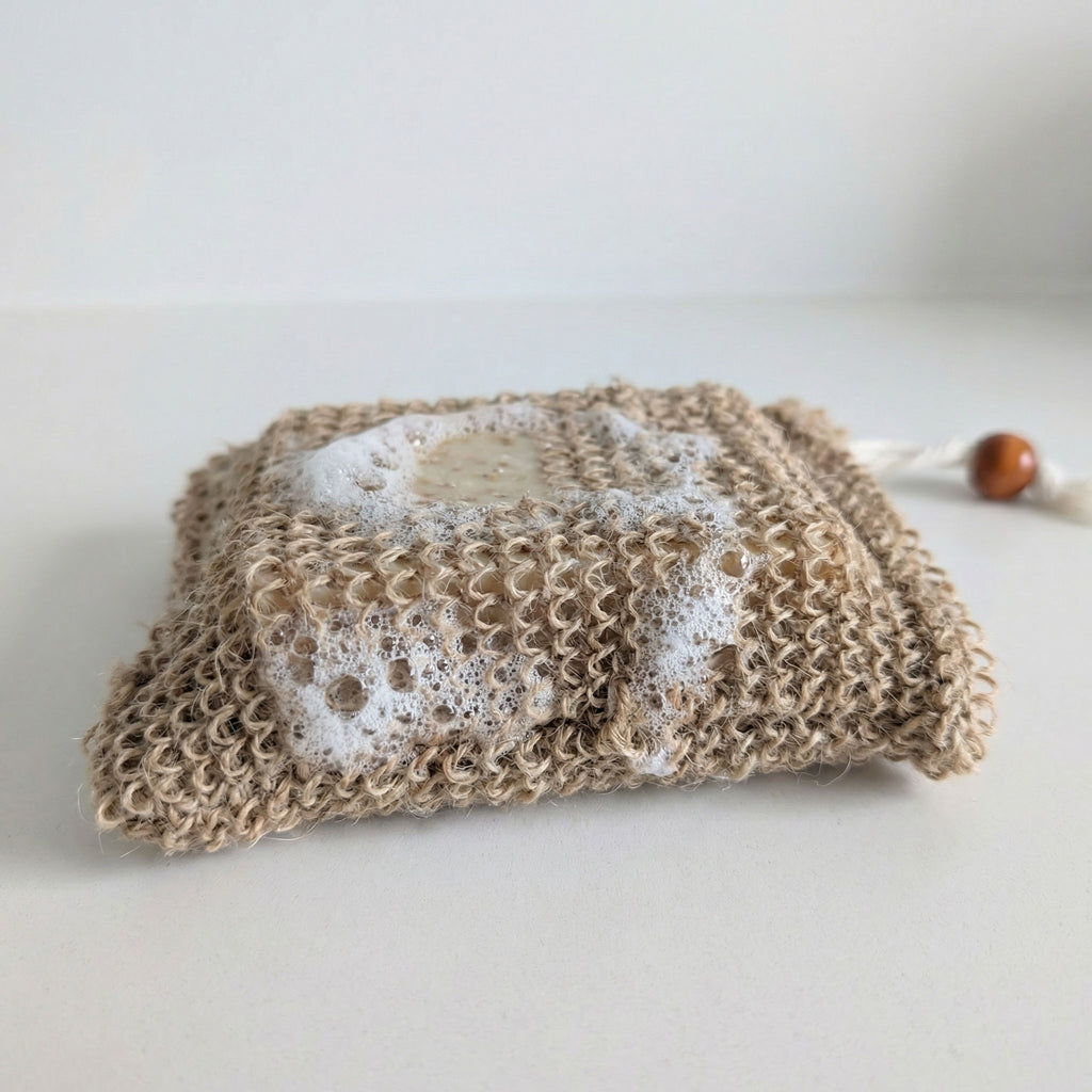 Hemp soap bag with lathered bar soap showing exfoliating texture and foam creation