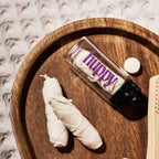 huppy dental floss flat lay styling - glass jar positioned on wooden tray with natural elements, highlighting sustainable packaging and elegant bathroom aesthetic