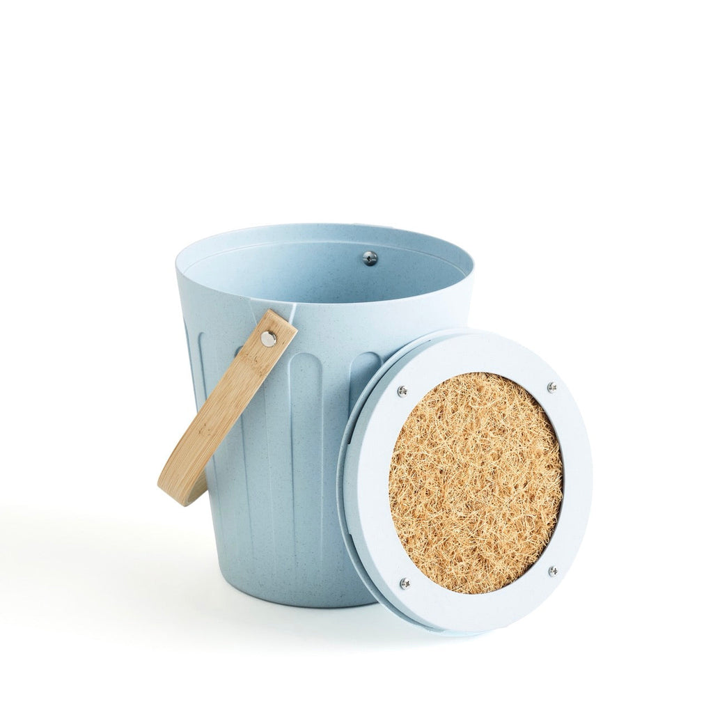 Martha Stewart light blue indoor compost bin with its lid open, revealing a filter on the underside.