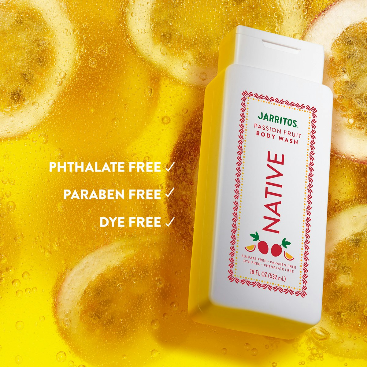 Native Jarritos Passion Fruit body wash bottle resting in bubbly yellow water with passion fruit slices.