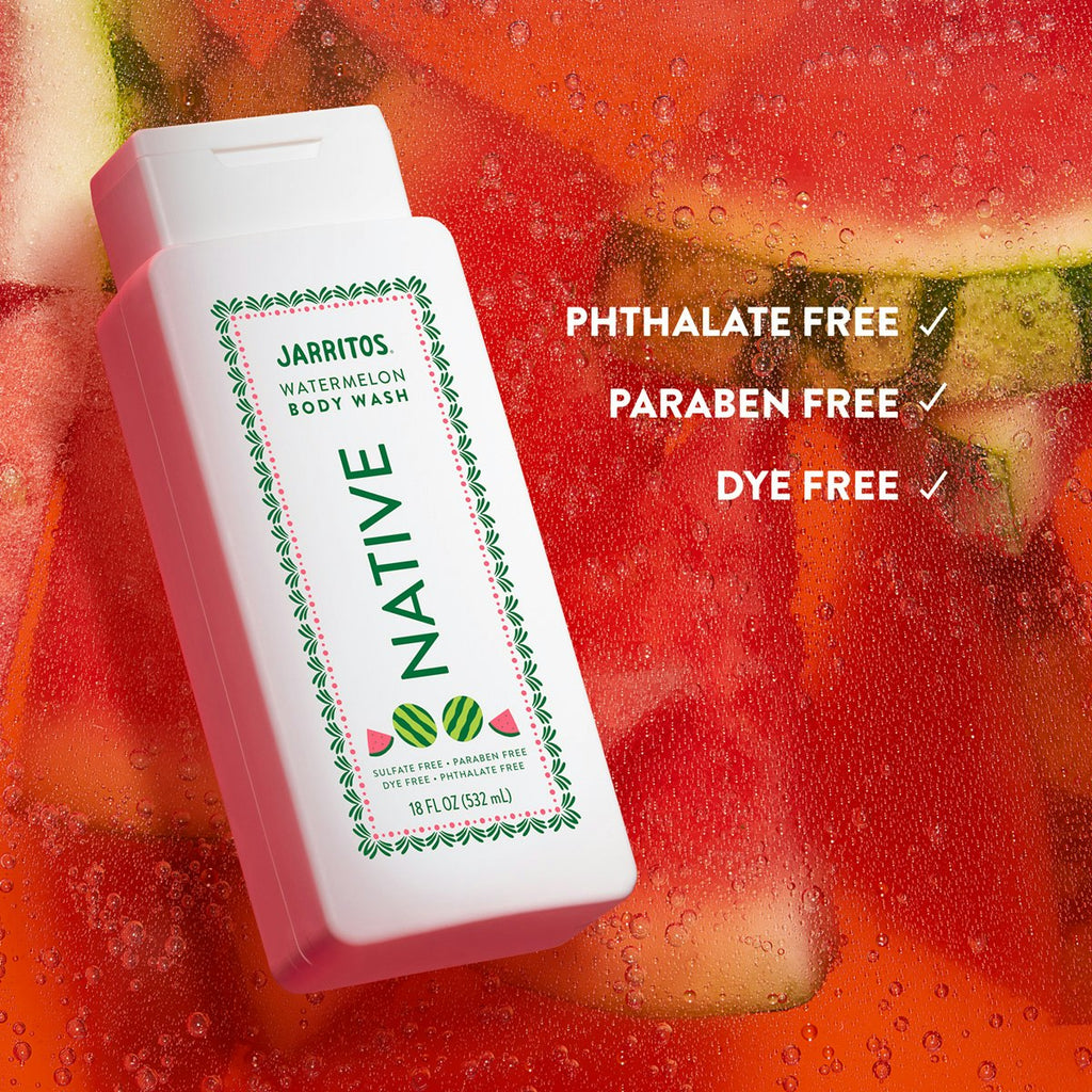 Native Jarritos Watermelon body wash bottle rests over glistening, wet sliced watermelons.