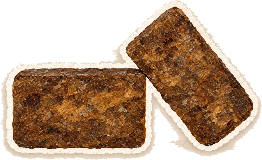 Paper cut-out of two rough bars of deep brown African black soap