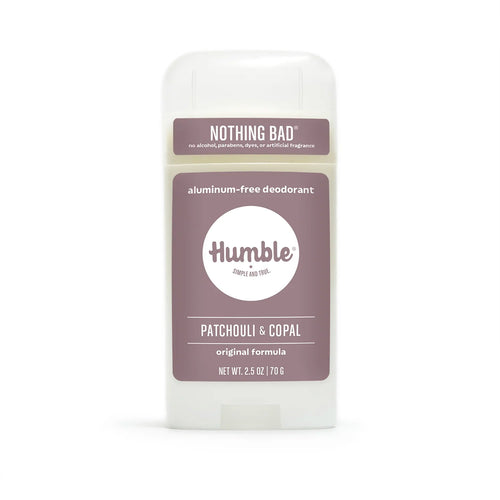 Humble Patchouli & Copal deodorant stick with a mauve label in a translucent white container on a white background.
