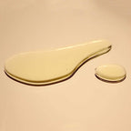 Close-up of golden-amber routine body oil texture showing smooth, clear botanical oil consistency with single drop demonstrating lightweight viscosity.