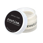 Routine Johnny's Cash vegan deodorant jar opened showing smooth cream texture - beeswax-free plant-based formula with woodsy masculine scent and cruelty-free protection