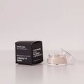Routine Johnny's Cash baking soda free mini deodorant showing black cardboard packaging next to open glass jar containing cream-coloured natural forest-scented deodorant