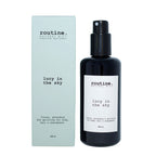 Routine Lucy in the Sky Natural Mist - front view of black glass bottle with pump dispenser and clean white label