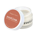 Routine Maggie's Farm deodorant - open glass jar displaying white cream texture with orange coral lid - natural ingredients visible in smooth consistency