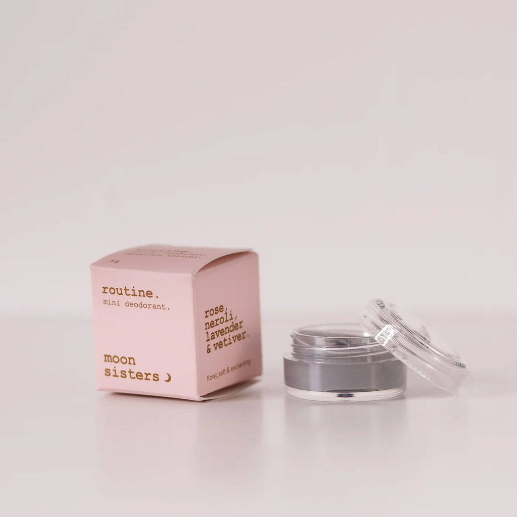 routine Moon Sisters mini deodorant - pink cardboard box beside open glass jar showing grey cream deodorant - floral natural formula with rose neroli lavender and vetiver