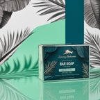 Tommy Bahama Lime & Coconut Bar Soap gift box displayed on a reflective teal surface with palm leaf shadows and tropical green backdrop