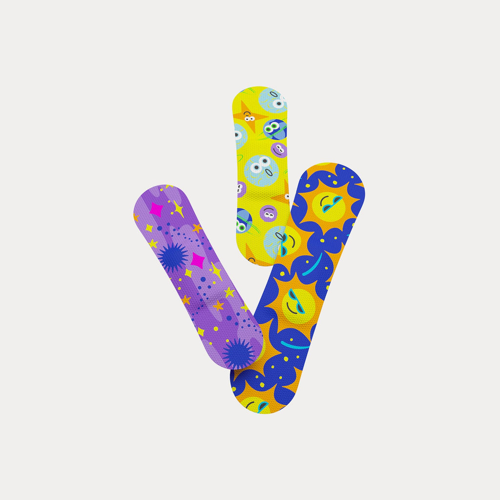 Trio of colourful Welly flex fabric bandages printed with smiling suns, stars, and celestial patterns.