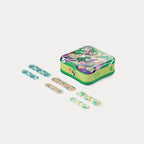 Angled view of the Welly bandage tin next to six colourful, tropical-patterned fabric bandages.