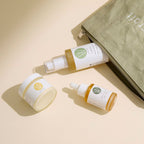 Three Wildcraft skincare bottles lie on a beige surface next to an open olive green zippered pouch.
