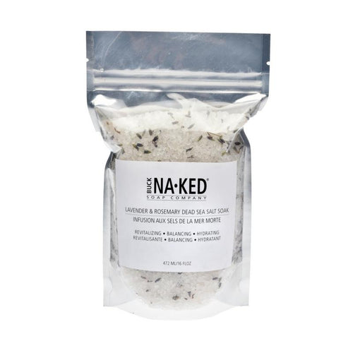 Clear pouch of Buck Naked Soap Company Lavender & Rosemary Dead Sea Salt Soak filled with white salts and purple botanicals.