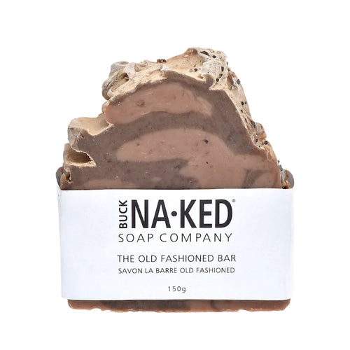 A brown and beige swirled bar soap with an uneven top, wrapped in a Buck Naked Soap Company paper label.
