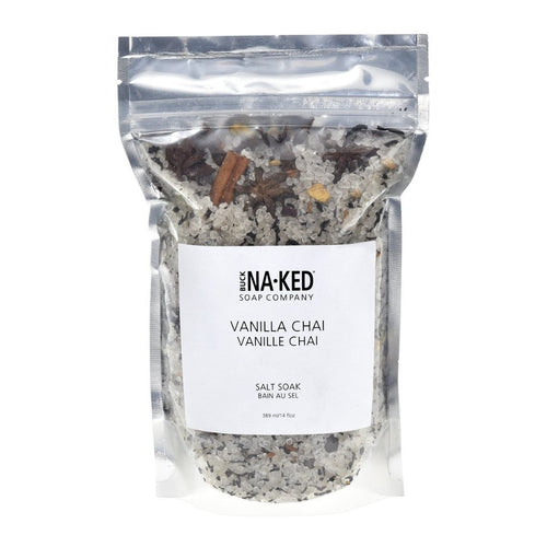 A clear pouch of Buck Naked Vanilla Chai Salt Soak shows white salt crystals mixed with star anise and cinnamon.